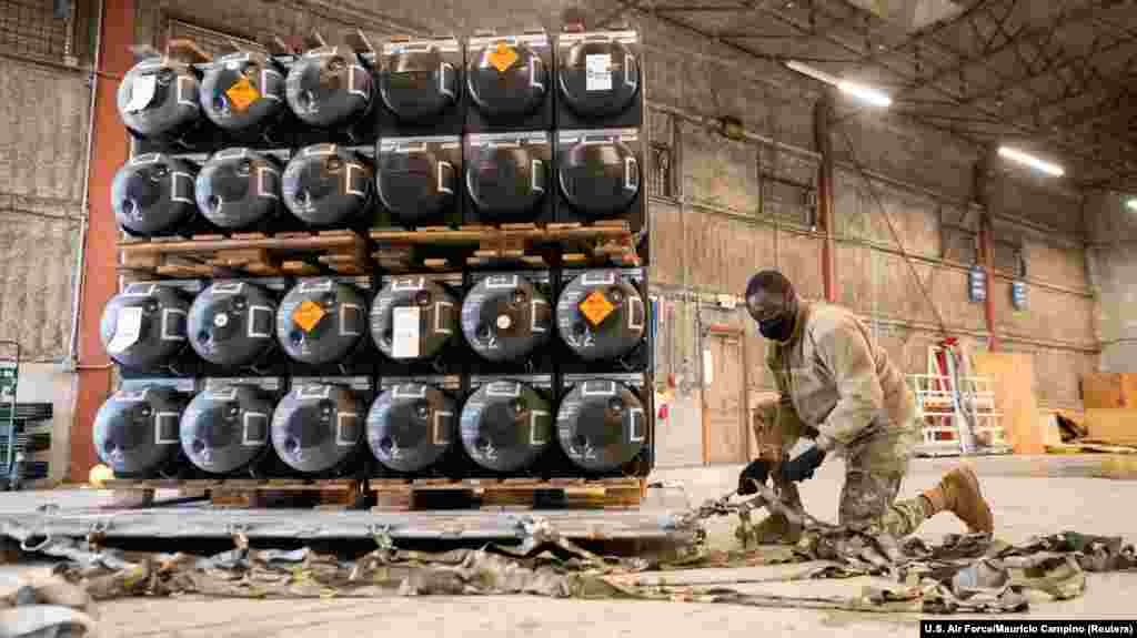 A U.S. airman prepares a pallet of ammunition, weapons, and other military supplies bound for Ukraine at Dover Air Force Base in Delaware on January 21. 