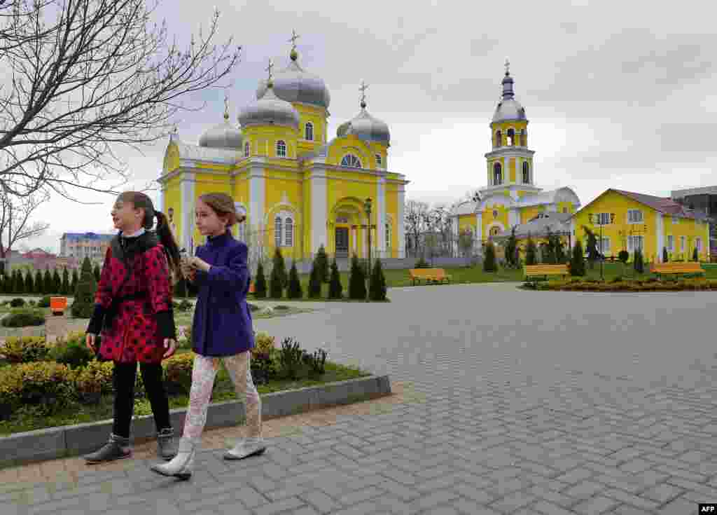 Children walk in a park in Comrat.