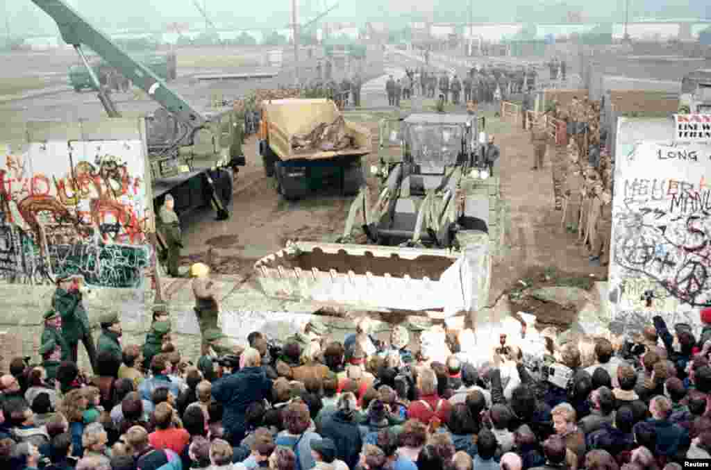November 1989: Fall of the Berlin Wall. A bungled press conference by an East German official gives the impression that the borders between East and West are open and curious crowds pour onto the streets. Faced with thousands of excited Berliners, panicked border guards lower their weapons and let people through. A trickle becomes a flood and the wall is soon destroyed. 