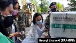 A North Macedonian health worker marks boxes of the Sinopharm COVID-19 vaccine before storing it in a cold room at the Jane Sandanski Clinic in Skopje on April 30.