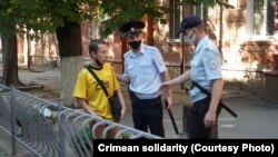 Police officers arrest a local resident in the Crimean capital, Simferopol. (file photo)