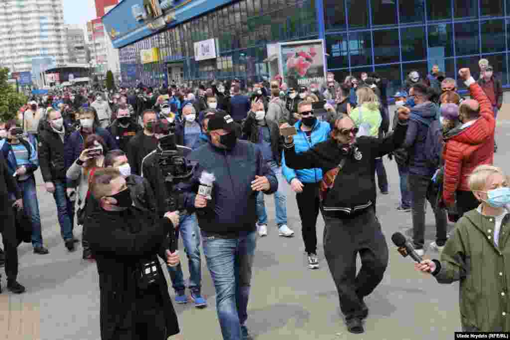 Opposition activist and blogger Syarhey Tsikhanouski (center) walks with his supporters during a rally. He was one of the organizers of the May 24 demonstration and was recently jailed over a previous &quot;unsanctioned mass gathering.&quot; Tsikhanouski&#39;s candidacy to run in the presidential vote was rejected by the authorities.