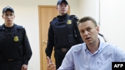 Russian opposition leader Aleksei Navalny speaks to journalists after a hearing in a Moscow court on June 12.