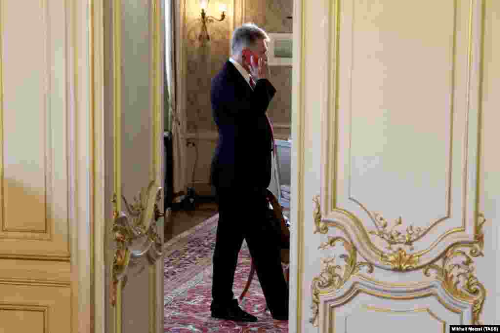 Kremlin spokesman Dmitry Peskov speaks on the phone inside the Villa La Grange. 