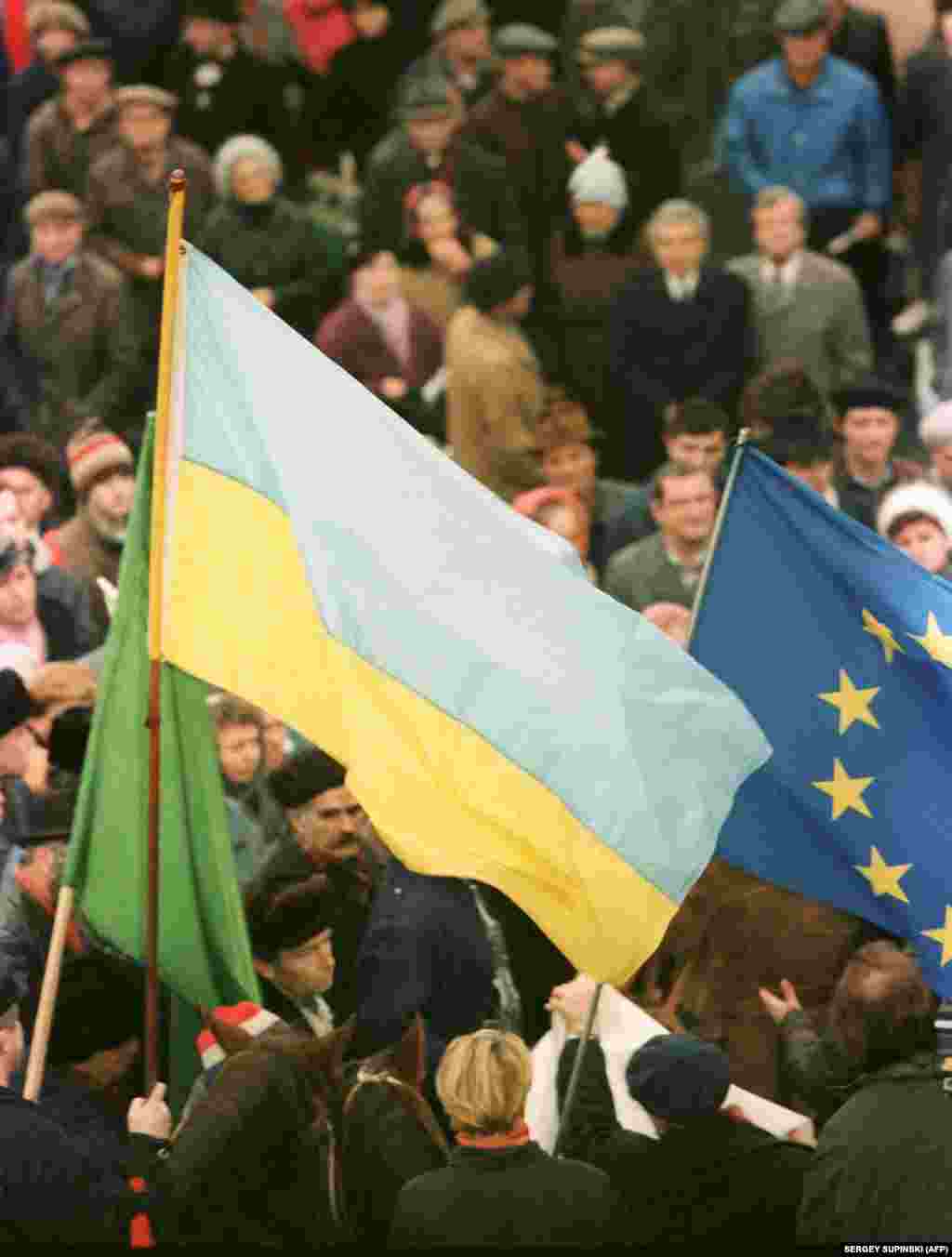 Both Ukrainian and European flags are seen during a pro-independence rally in Kyiv. 