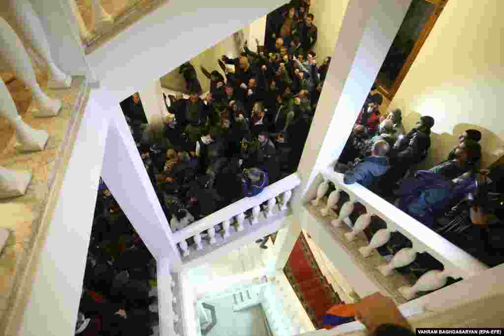 Protesters rampage inside a government building in Yerevan. The peace agreement would see Azerbaijan keep territory in Nagorno-Karabakh and surrounding areas taken from Armenian forces during the conflict. It also calls for Armenian troops to hand over areas they held outside the borders of Nagorno-Karabakh that had not been recaptured by Azerbaijani forces.