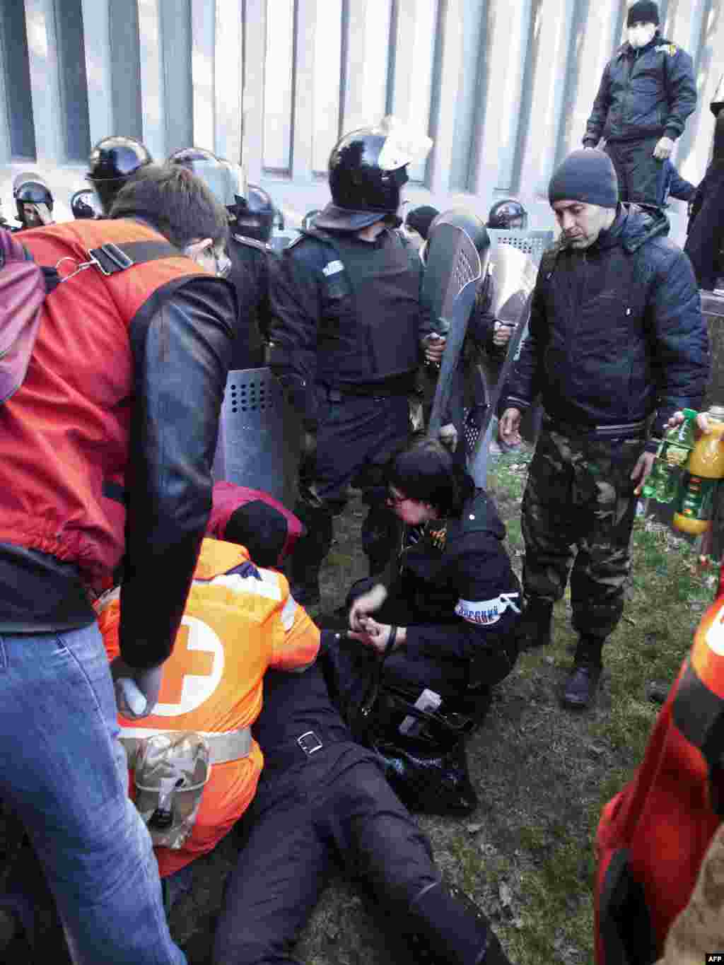 A wounded policeman receives medical assistance following clashes with pro-Russian activists who stormed the SBU building in Lugansk. 
