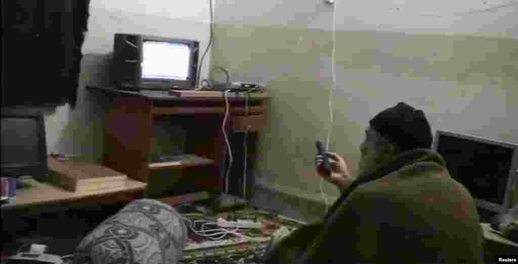 Bin Laden watches himself on television, likely at his hideaway in Abbottabad, Pakistan, in an undated home video. &nbsp; The Islamist fugitive managed to evade both the bombs and the U.S. Special Forces when he slipped across the border into Pakistan.