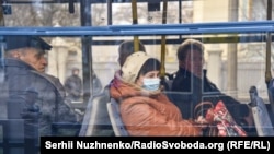 Ukrainians ride public transport in Kyiv, where the government closed the subway on March 17.