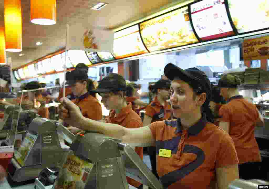 Staff attend to customers at a McDonald&#39;s restaurant in Moscow.