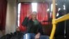 Anticorruption campaigner and opposition figure Aleksei Navalny waves as he sits inside a police van after after being detained during a rally in Moscow on March 26, 2017.