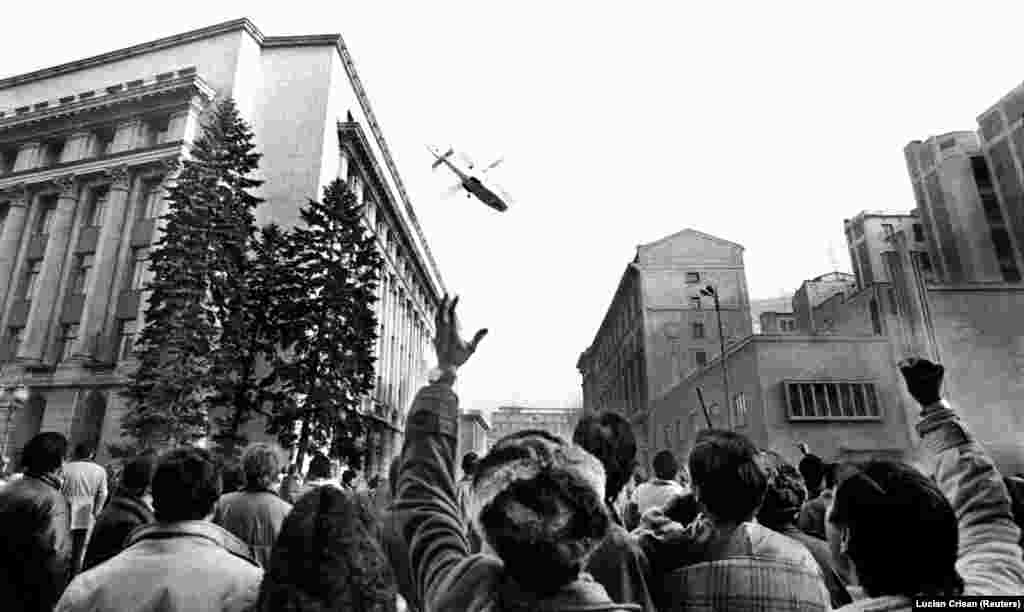 December 1989: Revolution in Romania. After scores of civilians are killed in a crackdown on antigovernment demonstrators, communist leader Nicolae Ceausescu makes a speech aimed at demonstrating the people’s "devotion" to him and his equally hated wife. Remarkable live footage of the address broadcasts the moment crowds begin jeering and the omnipotent tyrant shrinks into a confused old man. As people flood the streets the Ceausescus flee in a helicopter. They are soon caught and executed by firing squad. 