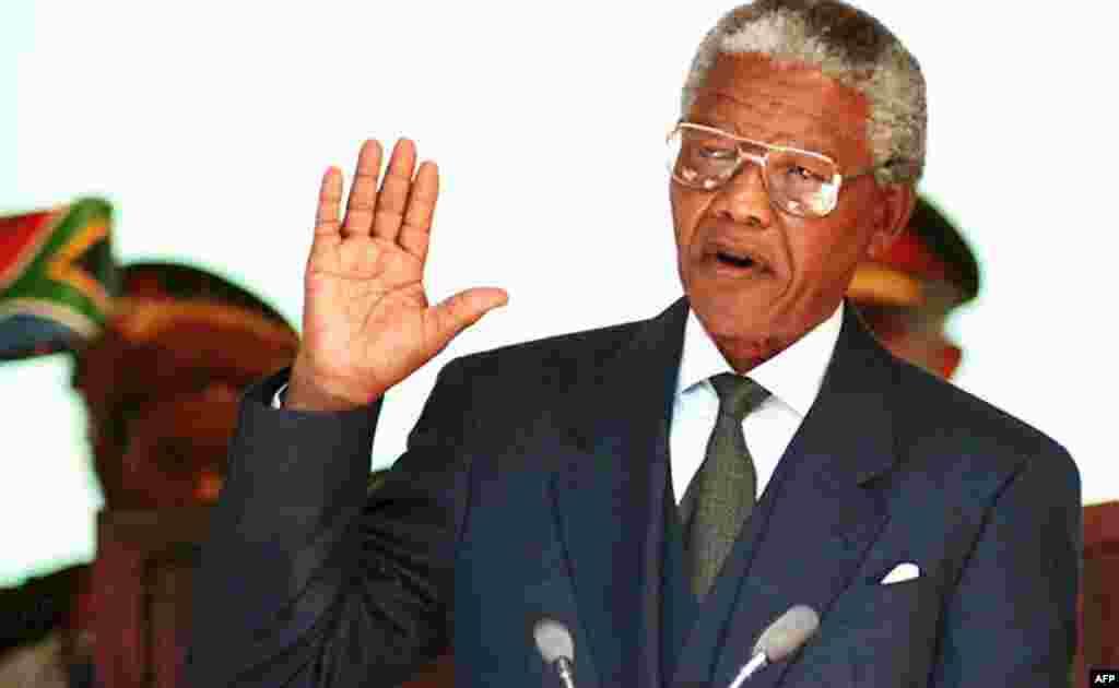 Nelson Mandela takes his oath of office during his presidential inauguration in Pretoria in May 1994. 