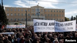 Грција - Демонстранти учествуваат во протестите пред зградата на Парламентот, по судирот на два воза во близина на градот Лариса. 5 март 2023 година. На транспарентот пишува „Не беше човечка грешка - Унија на Грчки железници“