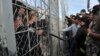 Refugees from Afghanistan protest against the closure of the Greek-Macedonian border earlier this week. A new Amnesty International report has criticized the European Union for failing to come up with "a coherent, humane, and rights-respecting response" to the challenge posed by the migrant crisis. 