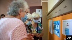 A woman checks instructions at a voting station in Bulgaria's inconclusive July election. Voters return to the polls on November 14.