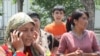 "We don't know where our men are," says Kholida Ahmedova (on the phone), one of several ethnic Uzbeks who sought shelter in the neighborhood of Otkhona in Osh shortly after ethnic clashes broke out in the city.