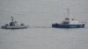 Ukrainian ships are seen being towed out of Kerch on November 17.
