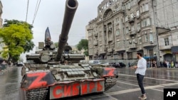 Wagner mercenaries sit atop a tank outside the headquarters of the Southern Military District in Rostov-on-Don, Russia, on June 24. Earlier, Wagner chief Yevgeny Prigozhin said his forces were making a "march of justice" to Moscow.