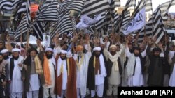Supporters of pro-Taliban Pakistani religious Jamiat Ulema-e Islam Nazryate party rally to celebrate the signing agreement between United States and Taliban in Quetta Balochistan in March 2020. 