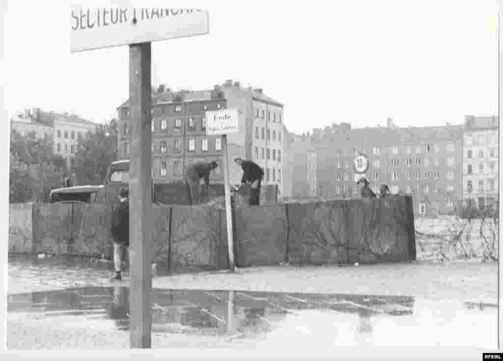 East German police patrol a temporary, prefabricated section of the Berlin Wall. After midnight on August 13, East German troops began erecting what Communist East German leader Walter Ulbricht called an &quot;anti-fascist protection barrier.&quot; Two months earlier, on June 15, he had declared: &quot;Nobody intends to build a wall.&quot;